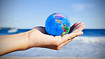 Hand holds a miniature globe